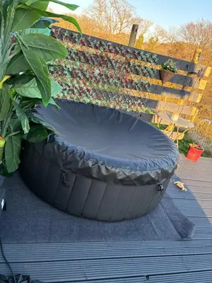 a large pot with a plant in it next to a bench at Lerags glen farm pods in Lerags