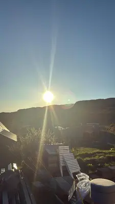 a view of the sun setting over a city at Lerags glen farm pods in Lerags
