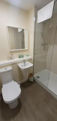 a bathroom with a toilet and a sink and a shower at Edenmill Farm in Glasgow