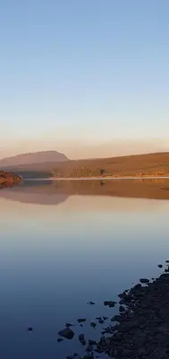 a view of a body of water with mountains in the background at Edenmill Farm in Glasgow