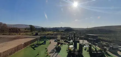 a park with a roller coaster in a field at Edenmill Farm in Glasgow