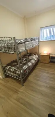 two bunk beds in a room with a window at Edenmill Farm in Glasgow