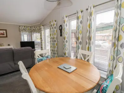 a living room with a table and a couch at Lodge 2 in Auchterarder