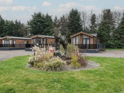 a statue of a statue of a deer in a park at Lodge 2 in Auchterarder
