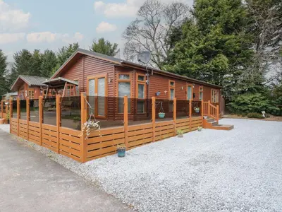 a log cabin with a porch and a deck at Lodge 2 in Auchterarder