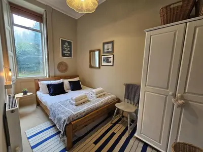 a small bedroom with a bed and a window at Comely Bank Coorie in Edinburgh