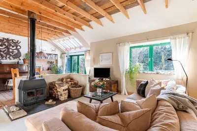 a living room with a couch and a fireplace at B&B on Beautiful Organic Homestead, Edinburgh in Loanhead