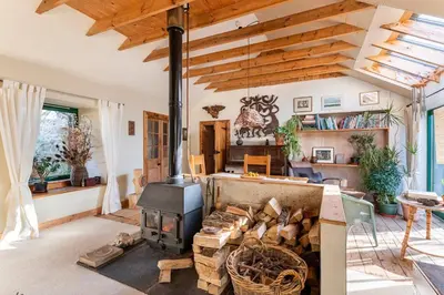 a living room with a wood stove at B&B on Beautiful Organic Homestead, Edinburgh in Loanhead
