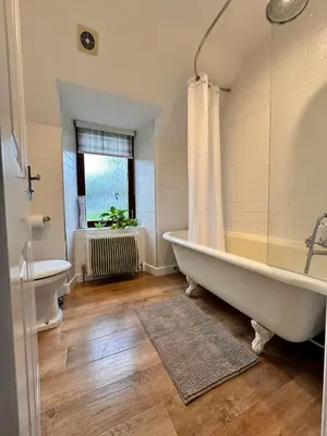 a bathroom with a tub and a toilet and a sink at Drymen View in Drymen