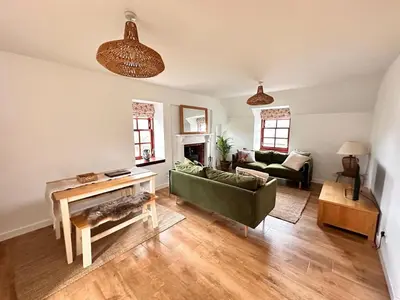 a living room with a couch and a table at Drymen View in Drymen