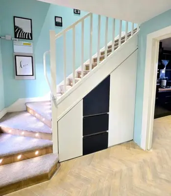 a room with stairs with a book shelf underneath it at Super luxury 2 bedroom, full house sleep 5 with garden & parking close to airport in Elderslie