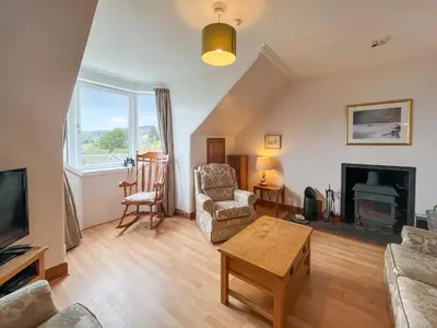a living room with a couch and a fireplace at Glengilp Apartment - Uk49317 in Ardrishaig