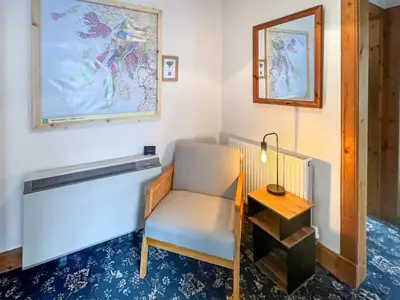 a room with a chair and a mirror and a table at Glengilp Apartment - Uk49317 in Ardrishaig