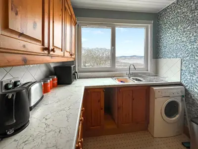 a kitchen with a sink and a washing machine at Glengilp Apartment - Uk49317 in Ardrishaig