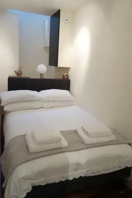 a white bed with white blankets and pillows on it at b&b in Edinburgh in Edinburgh