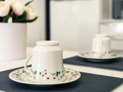a white tea pot on a plate on a counter at b&b in Edinburgh in Edinburgh
