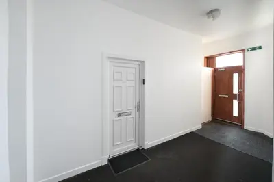 an empty room with a door and a hallway at Central 1-bed flat - Walk to shops, pubs and station in Saltcoats
