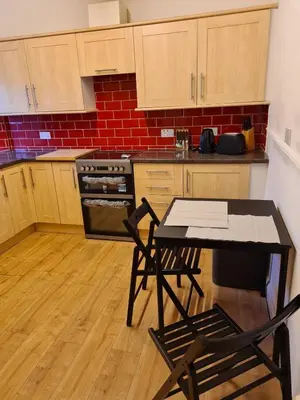 a kitchen with a table and two chairs in it at Our Salad Days Lochgilphead in Lochgilphead