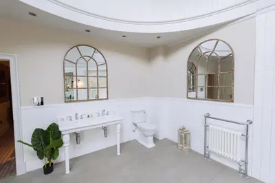 a white bathroom with a sink and a toilet at Cornhill Castle in Biggar