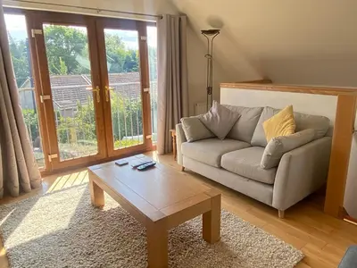 a living room with a couch and a coffee table at Loch Leven Loft in Milnathort