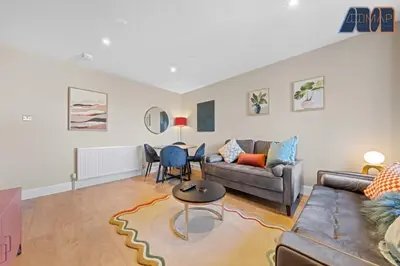 a living room with a couch and a table at 2 Bed Sleeps 4 in Dunfermline in Cairneyhill