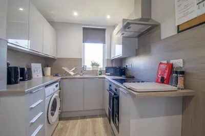 a kitchen with a washing machine and a washer and dryer at Highfield Apartment- 2 Bed in Motherwell close to centre in Motherwell