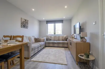 a living room with a couch and a table at Highfield Apartment- 2 Bed in Motherwell close to centre in Motherwell