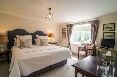 a bedroom with a large bed and a television at The Royal Hotel in Comrie