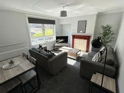 a living room with two couches and a table at 3-Bed Apartment Central Greenock in Greenock