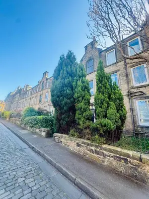 an empty street in front of a building at Haymarket Flat in Edinburgh