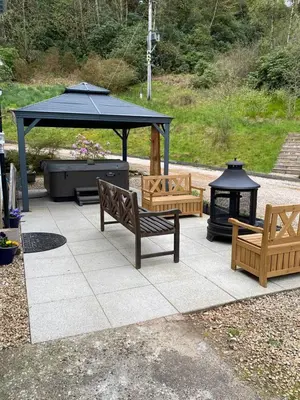 a patio with two benches and a gazebo at Sequoia House in Tarbet