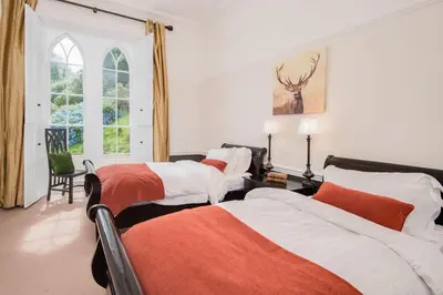 a bedroom with two beds and a window at Sequoia House in Tarbet