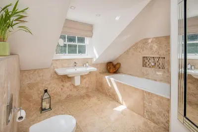a bathroom with a sink and a bath tub at Sequoia House in Tarbet