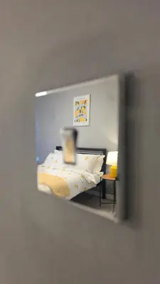 a mirror reflecting a bed in a bedroom at The Ansi8 in Livingston