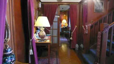 a hallway with purple curtains and a table with a lamp at Sandilands House in Edinburgh