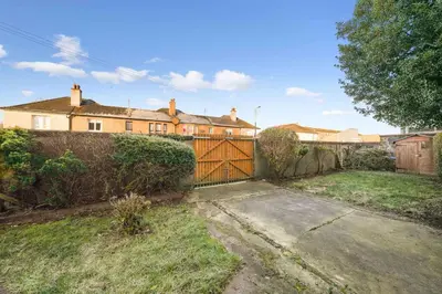 a house with a wooden gate in a yard at Large Terraced Home with Parking in Glasgow