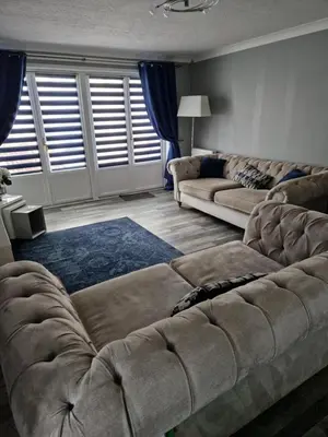 a living room with two couches and a couch at The Cottage in Kirk of Shotts