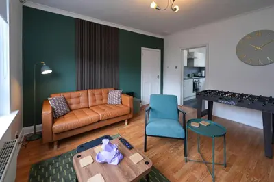 a living room with a couch and a table at Barassie Villa located near Troon in Troon