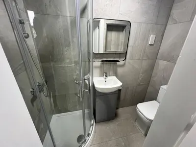 a bathroom with a shower and a sink and a toilet at The Dixon - Commonwealth Games 2026 in Glasgow