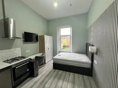 a small room with a bed and a kitchen at The Dixon - Commonwealth Games 2026 in Glasgow