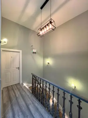 a staircase in a house with a light fixture at The Dixon - Commonwealth Games 2026 in Glasgow