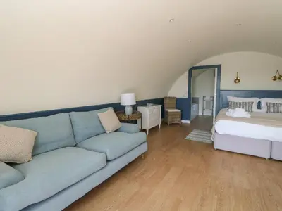 a living room with a couch and a bed at Torsa in Oban