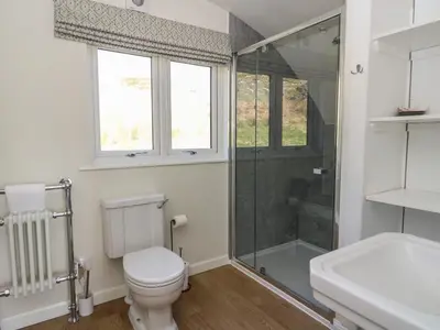 a bathroom with a toilet and a shower and a sink at Torsa in Oban