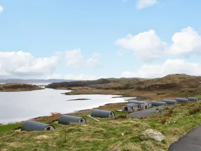 a row of pipes on the side of a river at Fladda in Oban
