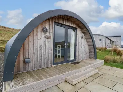a circular wooden cabin with a wooden deck at Fladda in Oban