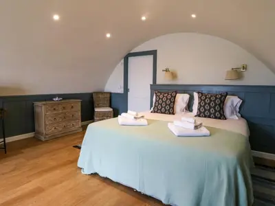 a bedroom with a large bed with towels on it at Creags in Oban