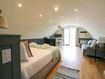 a bedroom with a bed and a living room at Creags in Oban