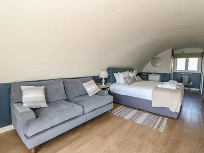 a living room with a couch and a bed at Scarba in Oban