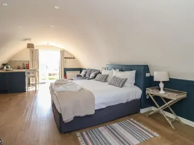 a bedroom with a large bed with a blue wall at Scarba in Oban