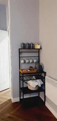 a shelf with bowls and other items in a room at KKLM Holidays in Largs